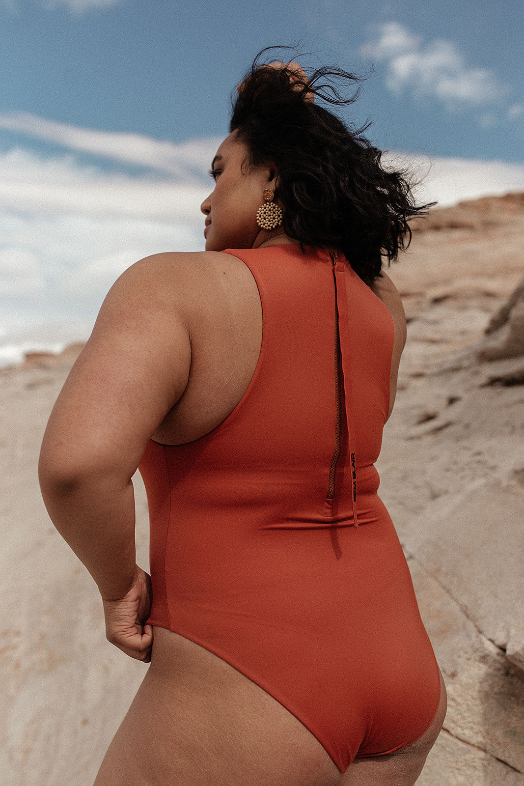 curvy model wearing red Body Suit One piece swimsuit with a perfect high neck body sculpting suit featuring zip on back